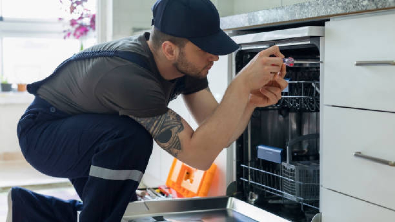 Technician examining dishwasher