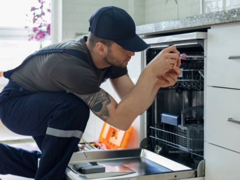 Technician examining dishwasher